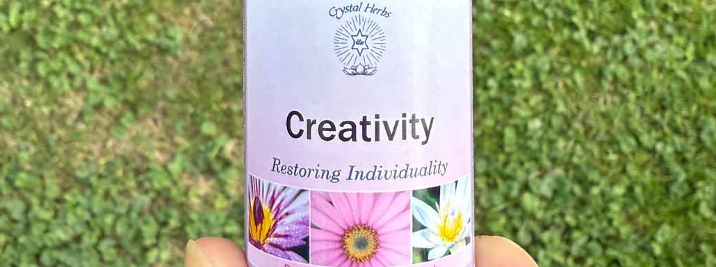 A bottle of Creativity Essence held in a hand