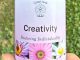 A bottle of Creativity Essence held in a hand